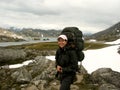 Girl hiking in snowfield and rockfield