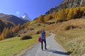Girl On Hiking Trail And Autumn Scene In Zermatt With Matterhorn Mountain In Background.