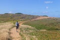 Girl hiking in Trail over the cliffs in Porto Covo