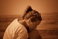 Girl on a hill in the desert. Ordinary people. Effect - Sepia.