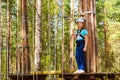 Girl on hinged trail in extreme rope Park Royalty Free Stock Photo