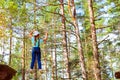 Girl on hinged trail in extreme rope Park Royalty Free Stock Photo