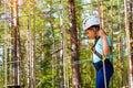 Girl on hinged trail in extreme rope Park Royalty Free Stock Photo