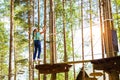 Girl on hinged trail in extreme rope Park Royalty Free Stock Photo