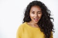 Girl hinting making first move. Cute sassy african american curly-haired woman in yellow sweater winking flirty and