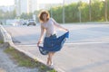 Girl, hippie, walking on side of carriageway