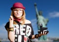 Girl in hipster glasses with polaroid on New York