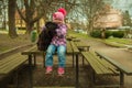 girl with his black schnauzer dog on a wooden bench Royalty Free Stock Photo