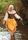 Girl in historical dress in water