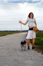 Girl hitchhiking with her dog Royalty Free Stock Photo