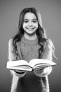 Girl hold book read story over orange background. Child enjoy reading book. Book store concept. Wonderful free childrens Royalty Free Stock Photo