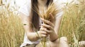 Girl hold in hand bunch of wheat