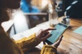 Girl hold in hands yellow mobile phone, person type message on empty screen smartphone in cafe, relax tourist travels plan trip Royalty Free Stock Photo