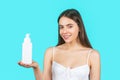 Girl hold in liquid soap bottle. Selfcare and beauty products concept. Smiling beautiful woman with holding shampoo or Royalty Free Stock Photo