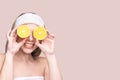 Girl hold orange slice. Citrus fruit hidding face