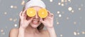 Girl hold orange slice. Citrus fruit hidding face