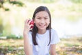 Girl holding apple and smiles in park Royalty Free Stock Photo