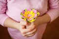 Girl holding an artificial flower from a children`s set for creativity