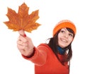 Girl holding autumn orange maple leaf.