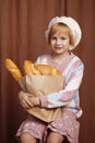 Girl holding bag full of bread. Royalty Free Stock Photo