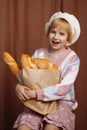 Girl holding bag full of bread. Royalty Free Stock Photo