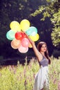 Girl holding balloons in hand