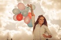 Girl holding balloons sky background Royalty Free Stock Photo