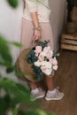 Girl holding a basket of flowers. Young girl with a large bouquet of flowers Royalty Free Stock Photo