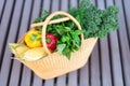 Girl holding basket with healthy organic vegetables, wooden background, copy space. Autumn harvest. Zero waste, plastic free Royalty Free Stock Photo