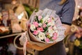 Girl holding a beautiful bouquet of pink tulips and white ranunculuses Royalty Free Stock Photo