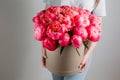 Girl holding beautiful mix coral and pink flower bouquet in round box with lid. peonies grade Coral Sharm. Royalty Free Stock Photo