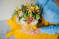Girl holding beautiful mix flower bouquet in round box with lid Royalty Free Stock Photo