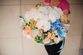 Girl holding beautiful mix flower bouquet with white orchid Royalty Free Stock Photo