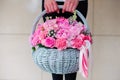 Girl holding beautiful pink bouquet of mixed flowers in basket Royalty Free Stock Photo