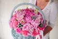 Girl holding beautiful pink bouquet of mixed flowers in basket Royalty Free Stock Photo