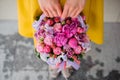 Girl holding beautiful pink bouquet of mixed flowers in basket Royalty Free Stock Photo