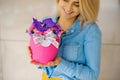 Girl holding beautiful pink bouquet of mixed flowers in vase Royalty Free Stock Photo