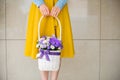 Girl holding beautiful purple bouquet of mixed flowers in basket Royalty Free Stock Photo