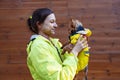 Girl holding a biewer terrier dog and looking away in autumn park. Walk with pet concept.