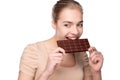 Girl holding big chocolate bar in her tooths Royalty Free Stock Photo