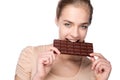 Girl holding big chocolate bar in her tooths Royalty Free Stock Photo