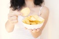 A girl holding the big potato chips bowl. Asking to eating together Royalty Free Stock Photo