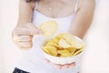 A girl holding the big potato chips bowl. Asking to eating together Royalty Free Stock Photo