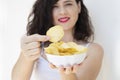 A girl holding the big potato chips bowl. Asking to eating together Royalty Free Stock Photo