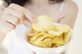 A girl holding the big potato chips bowl. Asking to eating together Royalty Free Stock Photo