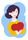 A girl holding a big red heart. Valentine`s Day. Beautiful young girl with a short haircut. Sweet enamored girl with a heart in