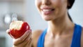 Girl holding bite apple replenishing her body with vitamins, healthy teeth Royalty Free Stock Photo