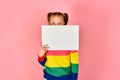 Girl holding a blank poster for inscription and text Royalty Free Stock Photo