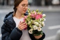 Girl holding blossoming flower bouquet of eustoma flovers in hands on blurred background Royalty Free Stock Photo