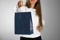 Girl holding a blue gift bag. Close up. Isolated background Royalty Free Stock Photo